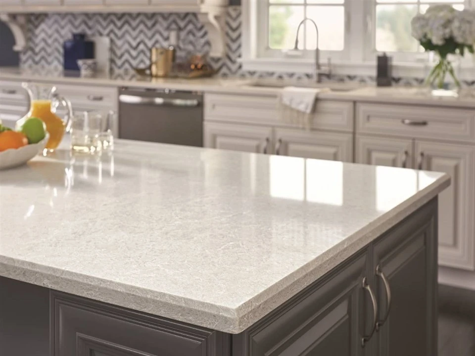 Light engineered quartz kitchen island with beveled countertop edge Light engineered quartz kitchen island with beveled countertop edge