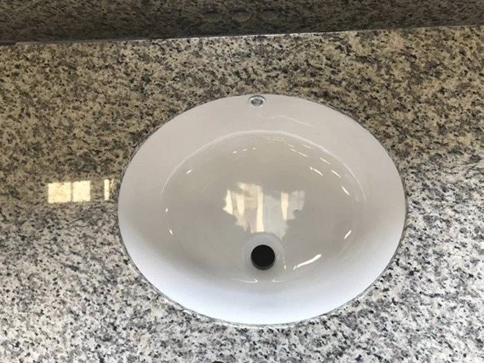 Undermount basin fitted in Tiger Skin White granite vanity top Undermount basin fitted in Tiger Skin White granite vanity top