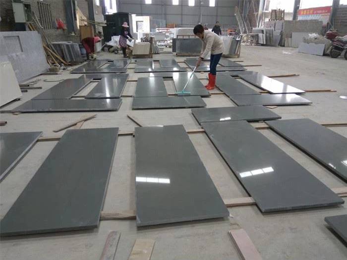 Grey quartz countertop pieces arranged for surface inspection Grey quartz countertop pieces arranged for surface inspection
